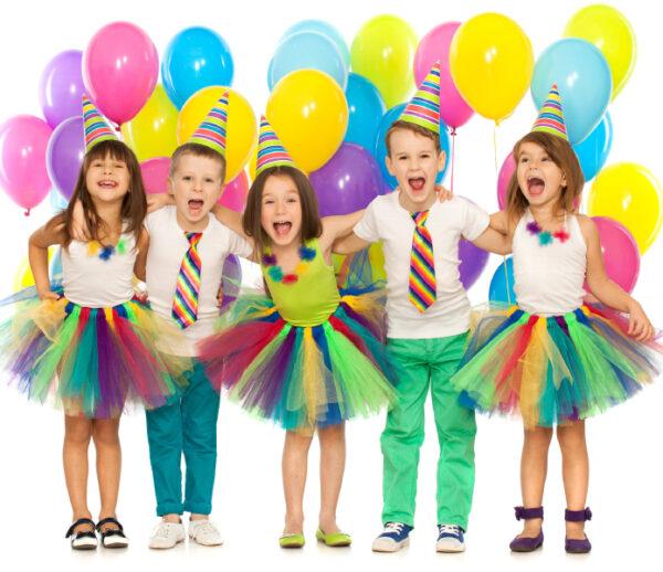 Group of joyful little kids having fun at birthday party